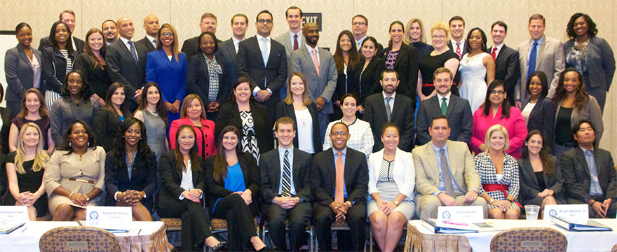 Leadership academy, a large group of people wearing business attire, photographed in a large meeting room