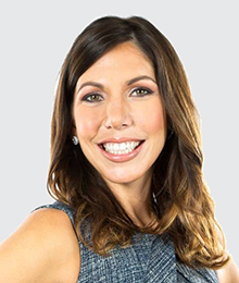 Alexandra Brzostowicki Kontos headshot, white background, wearing a sleeveless gray top