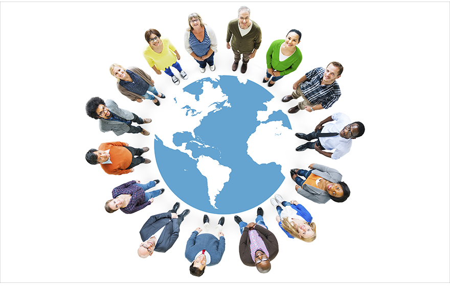 A group of diverse people standing around an illustration of the globe