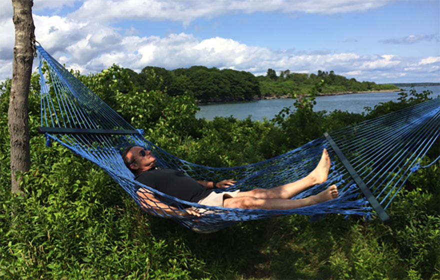 Judge Gary Flower relaxes on a hammock near a body of water
