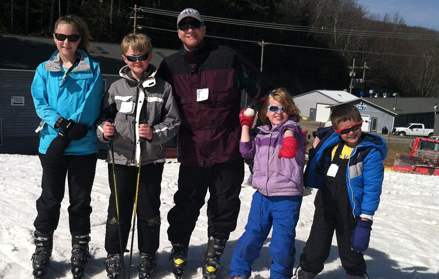 Judge Osterhaus is pictured with a group of children on a ski hill