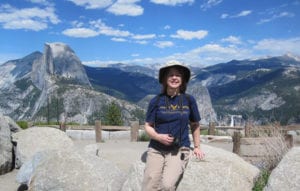 Judge Susan Kelseyis hiking in the mountains on a beautiful sunny day