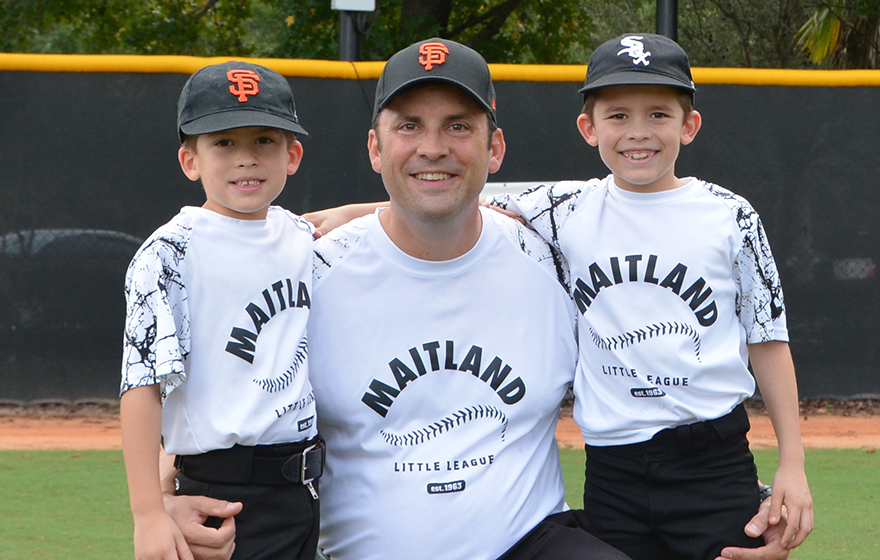 Judge Willis is pictured on the field with two young baseball players