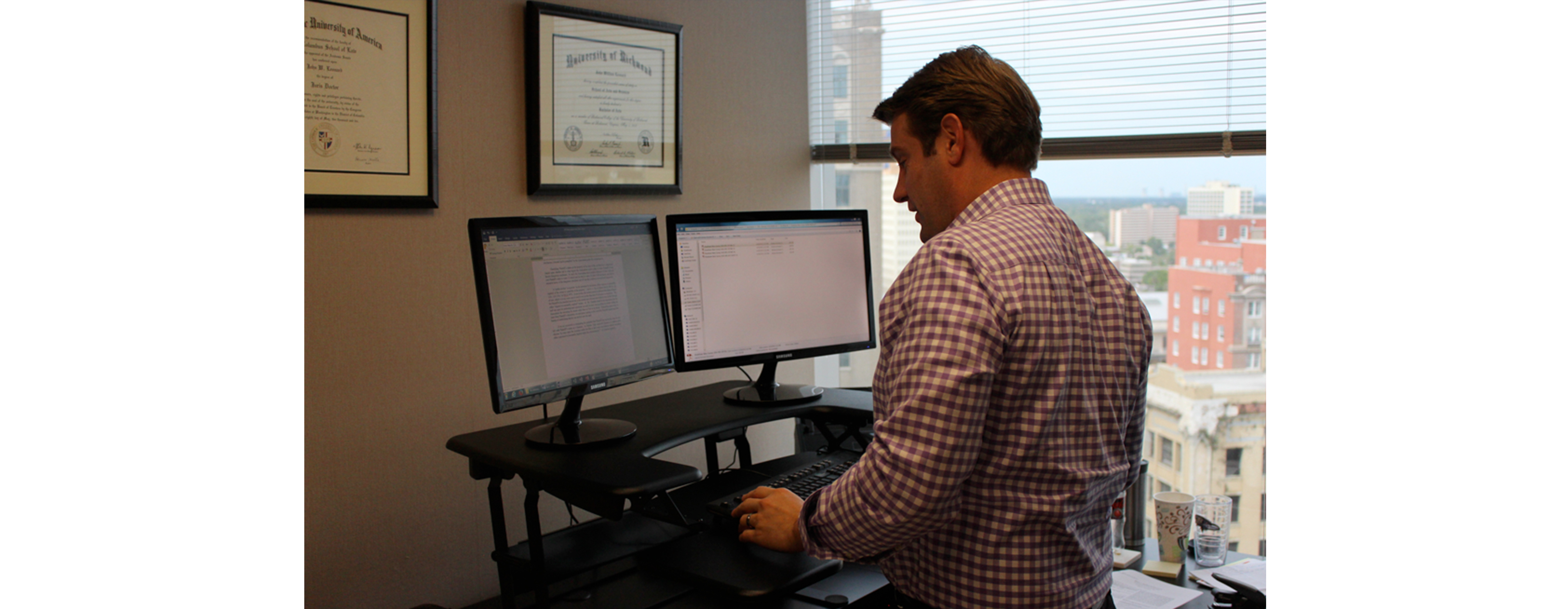 FLAYLD_HealthWellness_DawsonOrr_2016_White_StandupDesk1 A young businessman is using a stand up desk in an office setting