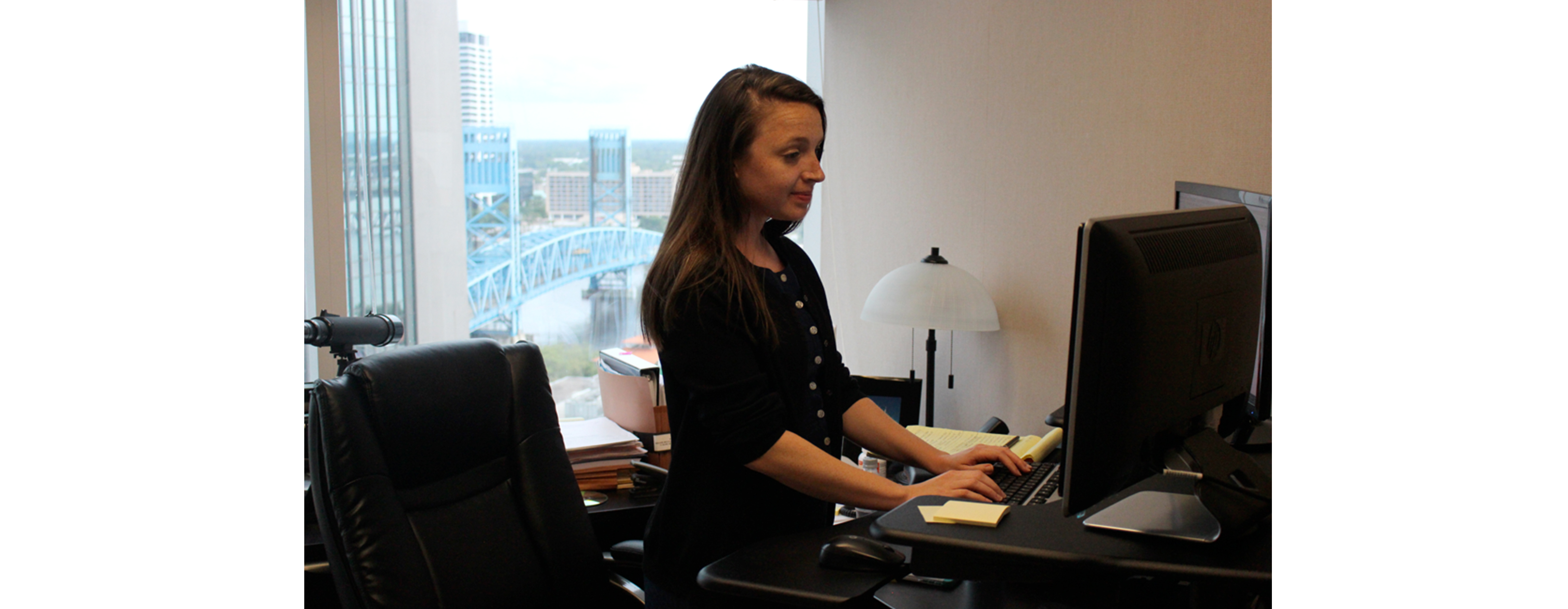 FLAYLD_HealthWellness_DawsonOrr_2016_White_StandupDesk2 A young businesswoman is using a stand up desk in an office setting