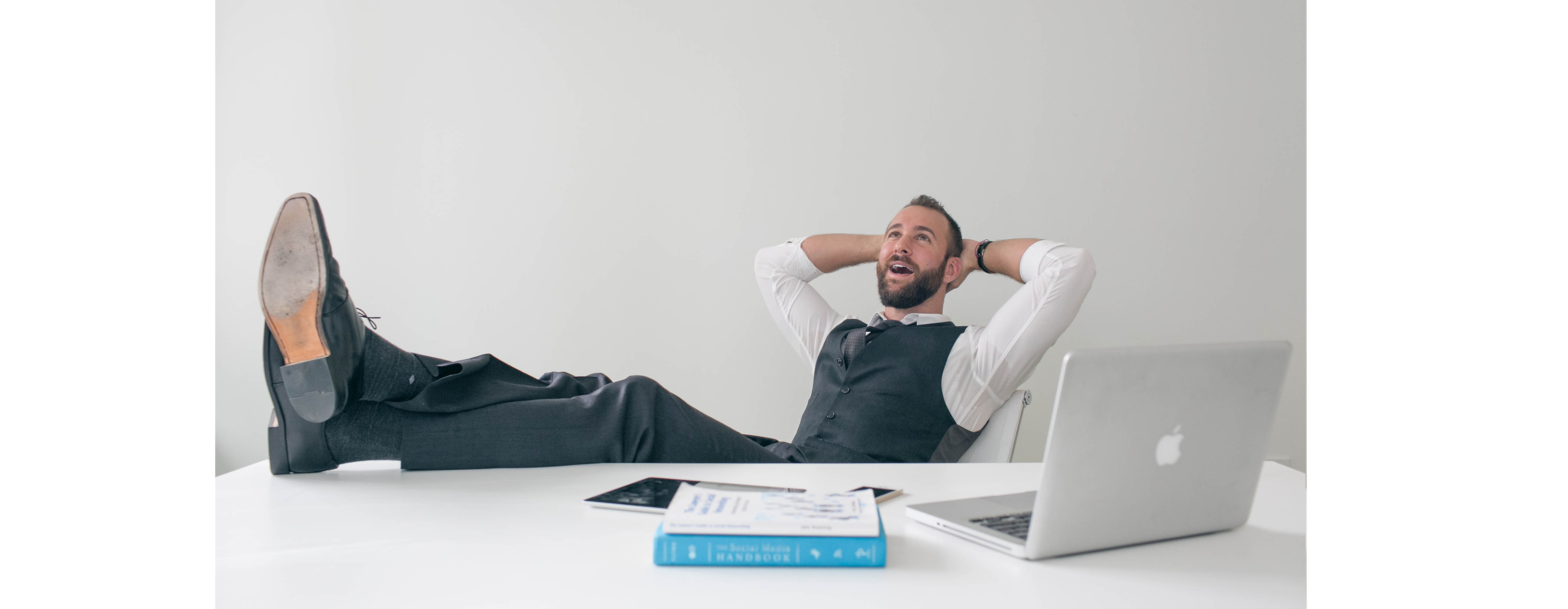 Relaxed businessman sits with his feet up on the desk