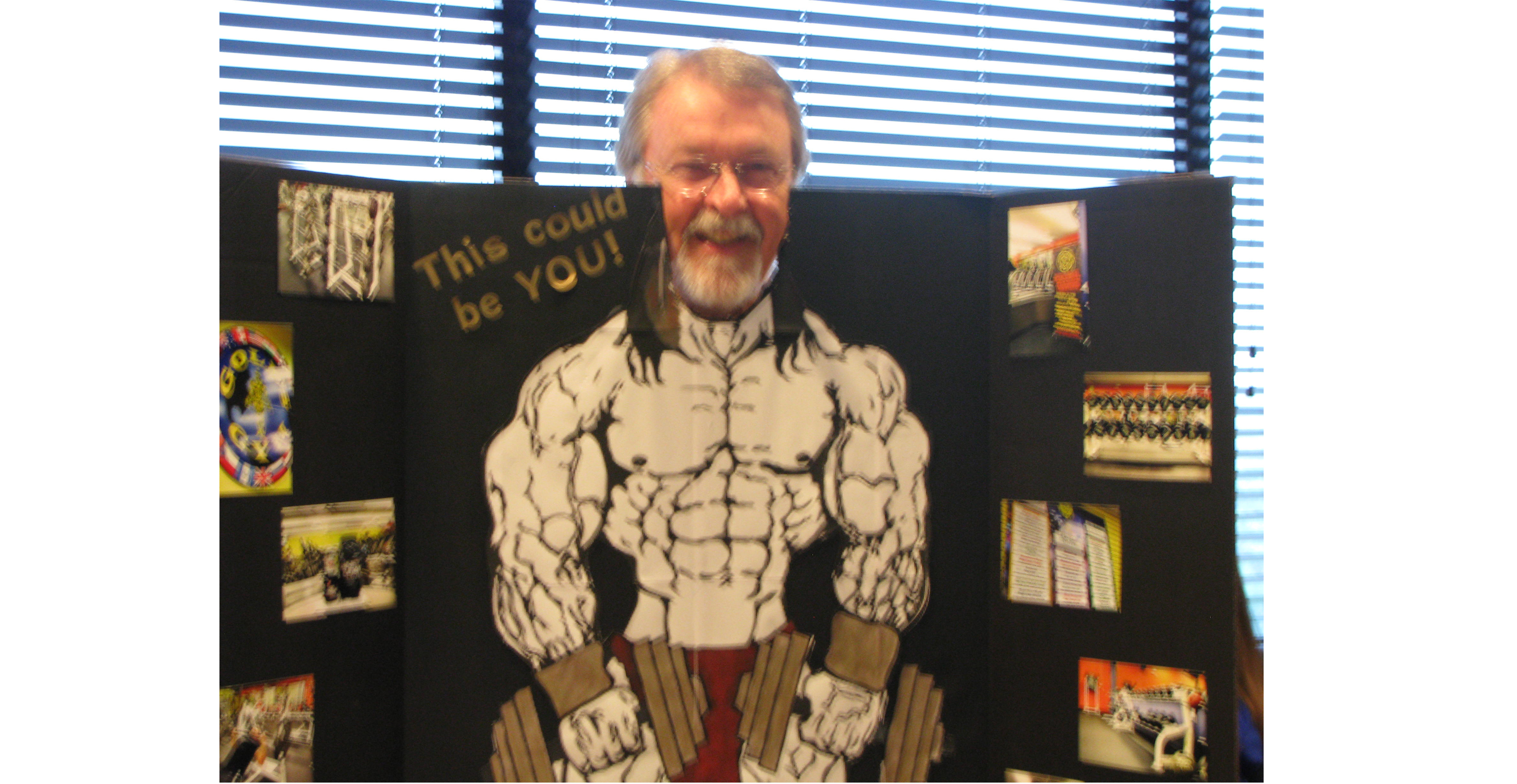 Larry Williams is pictured peeking out from a board with muscular man drawn on it