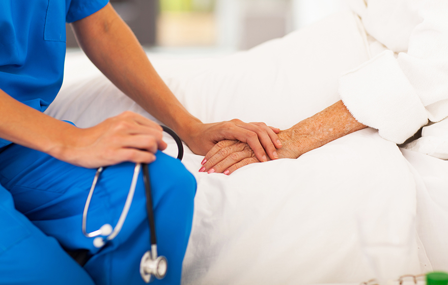 Medical doctor comforting senior patient