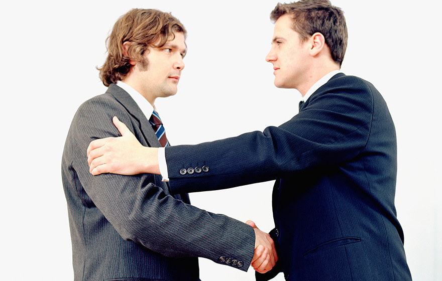 Two Caucasian businessmen shaking hands
