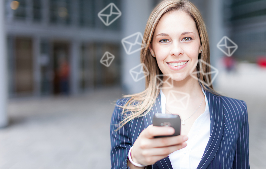 Businesswoman using a smartphone to send a message