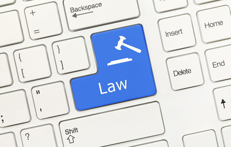 Close-up view on white conceptual keyboard - Law (blue key with gavel symbol)