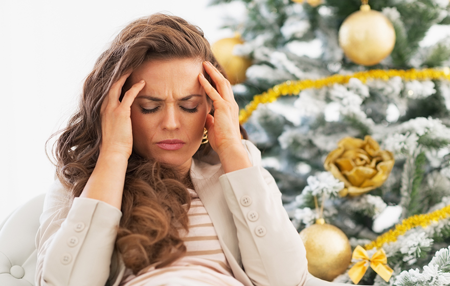 Portrait of frustrated young woman near christmas tree