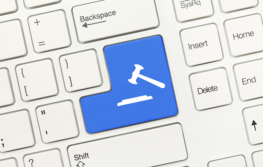 Close-up view on white conceptual keyboard - Blue key with gavel symbol