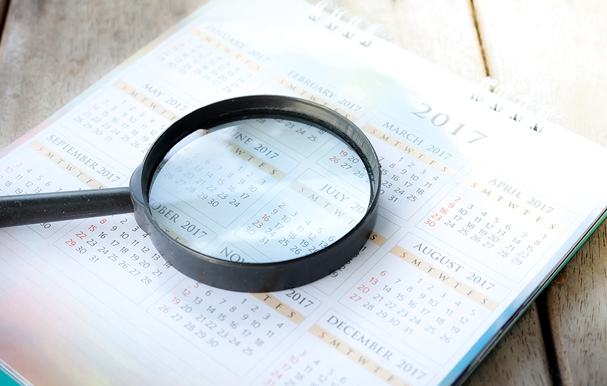 Magnifying glass over a calendar