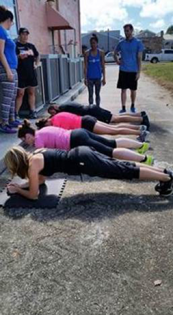 AWKO team exercising and doing planks together outdoors