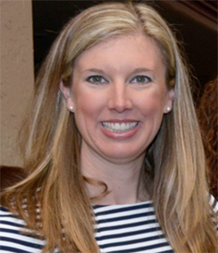 Amanda Gambert headshot of young smiling Caucasian woman with long blonde hair wearing a black and white striped blouse