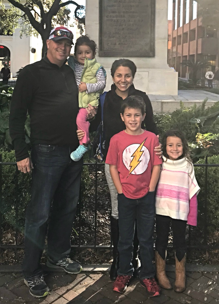 Michelle Bedoya Barnett photo Michelle Bedoya Barnett a smiling Latina woman with her husband and three young children, in a park setting.