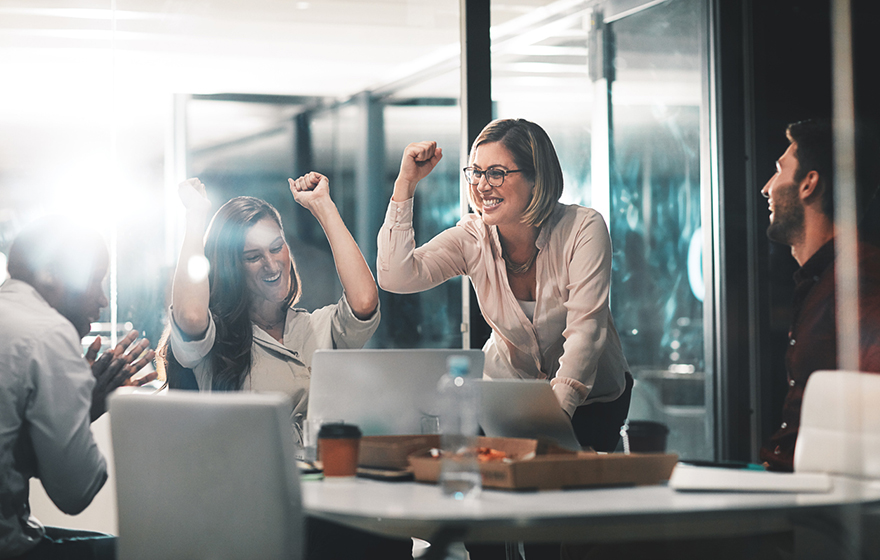 colleagues celebrating during a meeting in a modern office