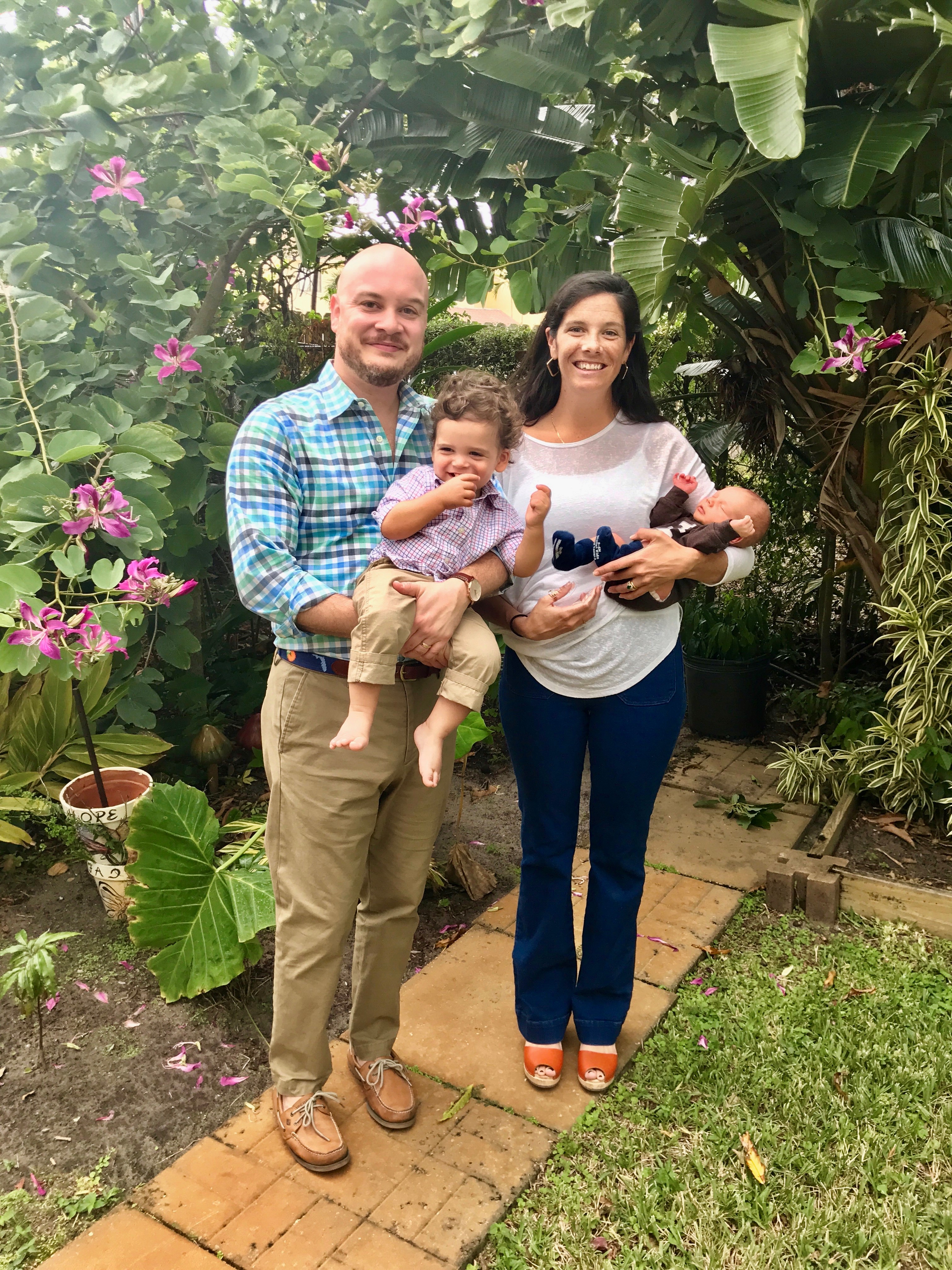 Santo Digangi a bald smiling Caucasian man with Caucasian wife with long brown hair and their two small children