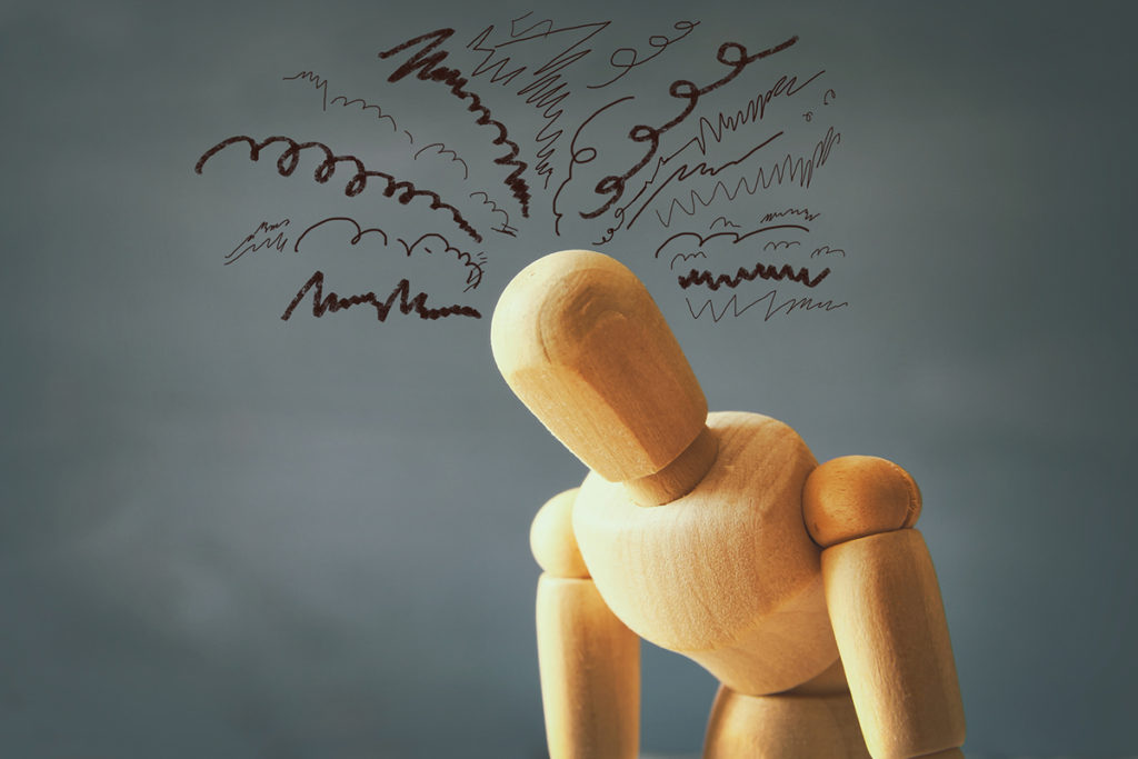 image of wooden dummy with worried stressed thoughts. depression, obsessive compulsive, adhd, anxiety disorders concept