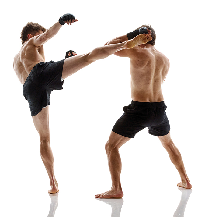 Two men doing mixed martial arts, Caucasian men in black shorts, kicking, muscular build, training gloves