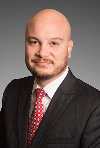 Santo DiGangi headshot, Caucasian Man in a black suit with red tie and white shirt, brown eyes, beard, bald
