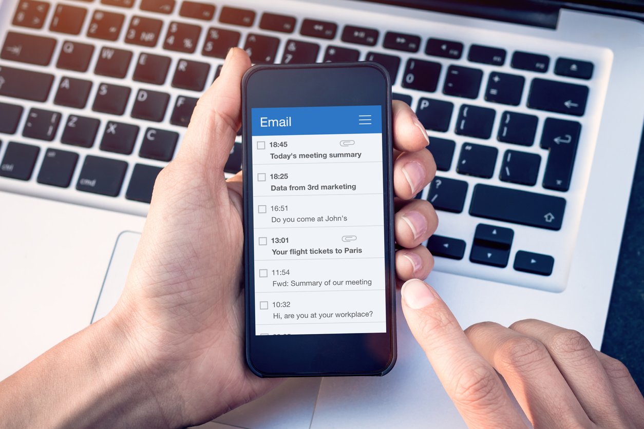 Email app on smartphone screen with business person reading messages from inbox with wireless internet access on mobile phone, communication technology